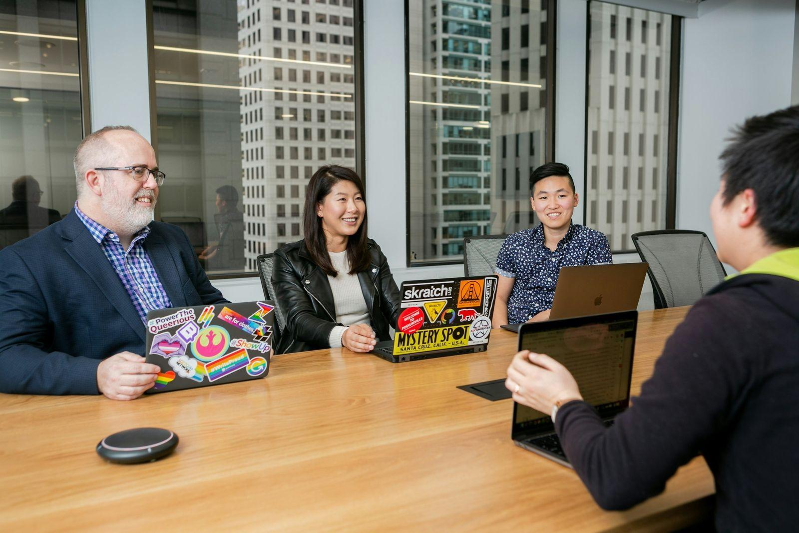 Team in a boardroom design meeting discussing platform integration architecture and AI discovery channels