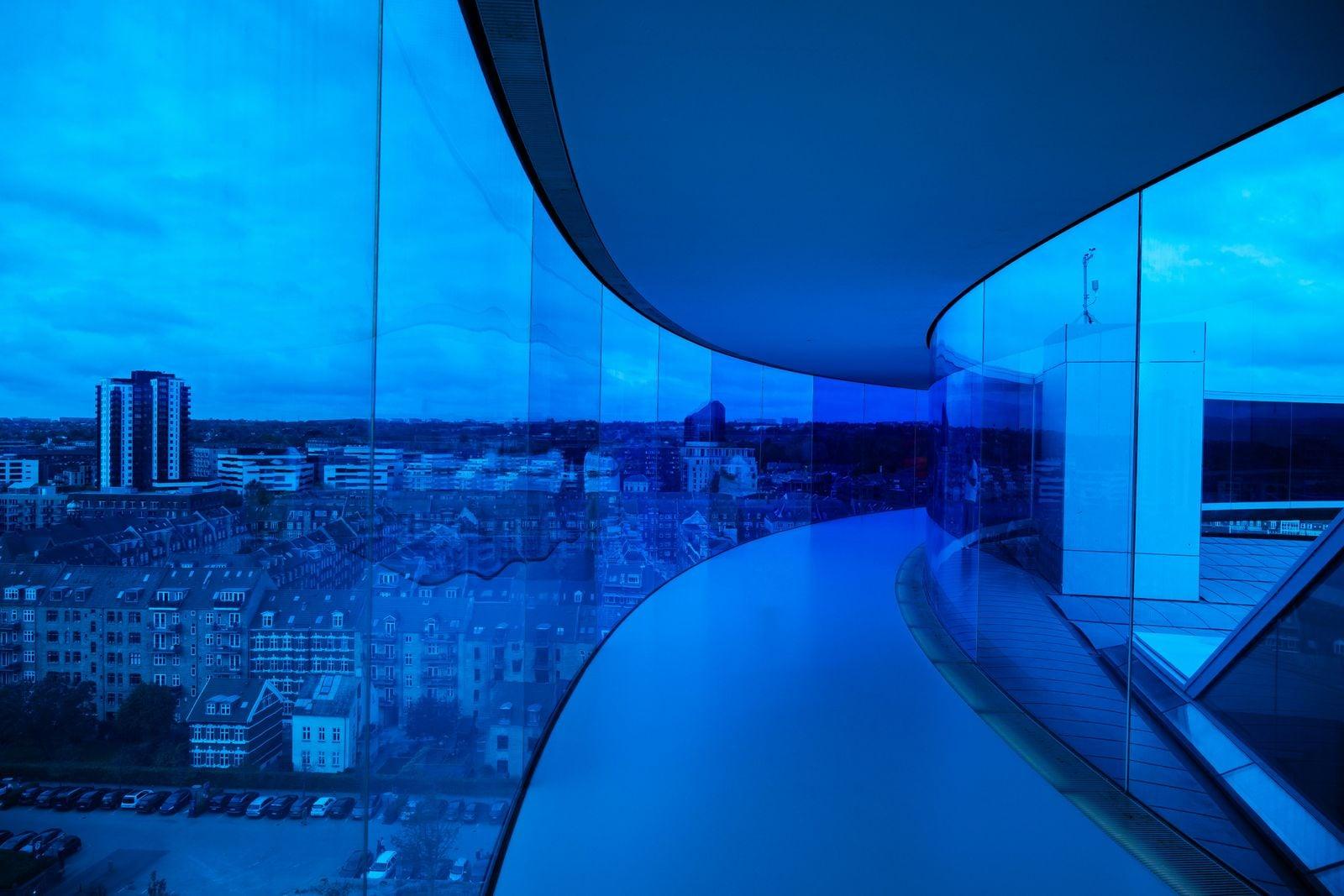 Modern building overlooking a city at dusk