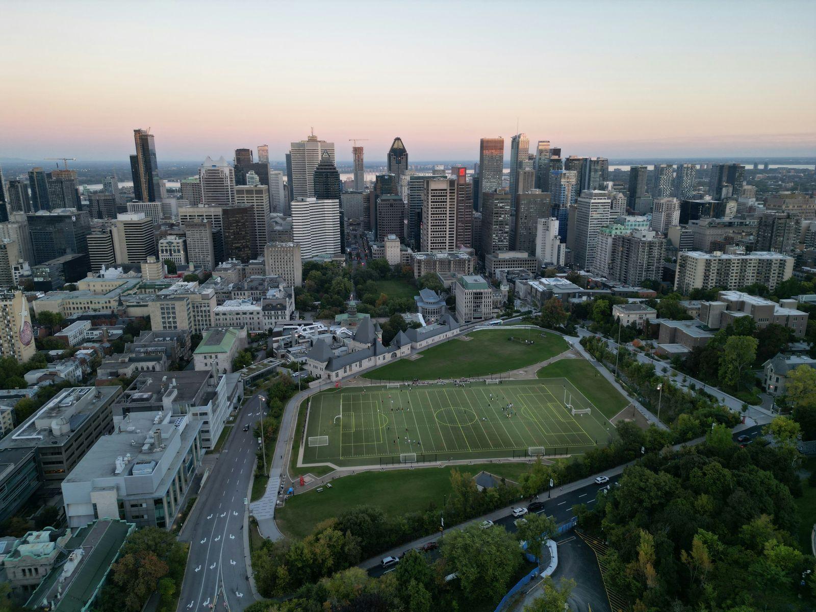 An aerial view of a city with a soccer field