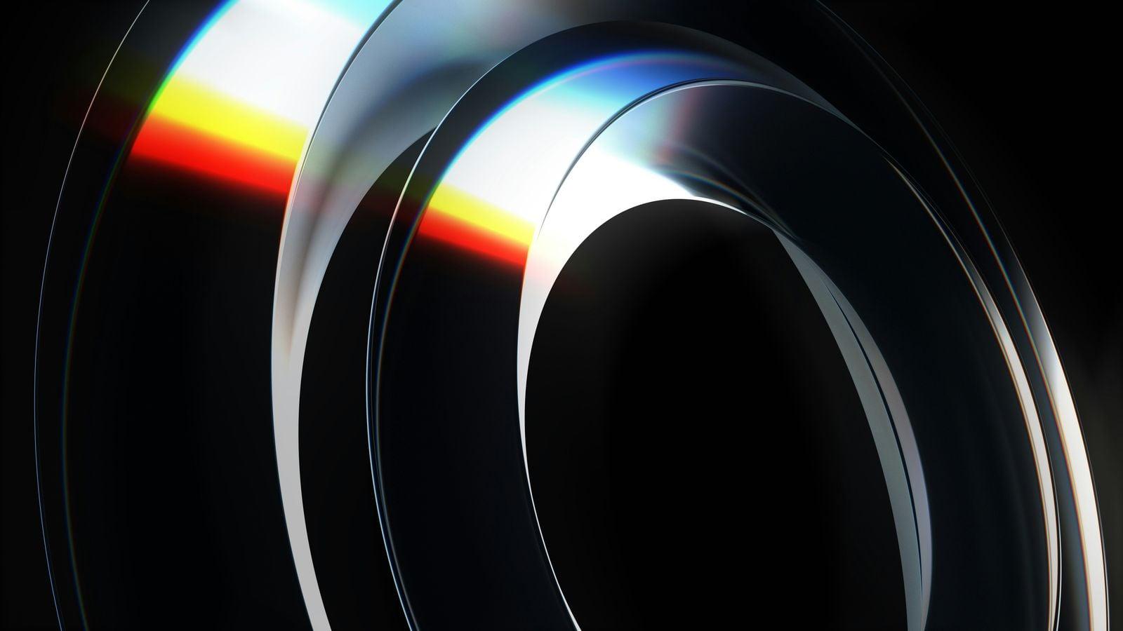 Abstract swirling metallic shapes with rainbow light reflection