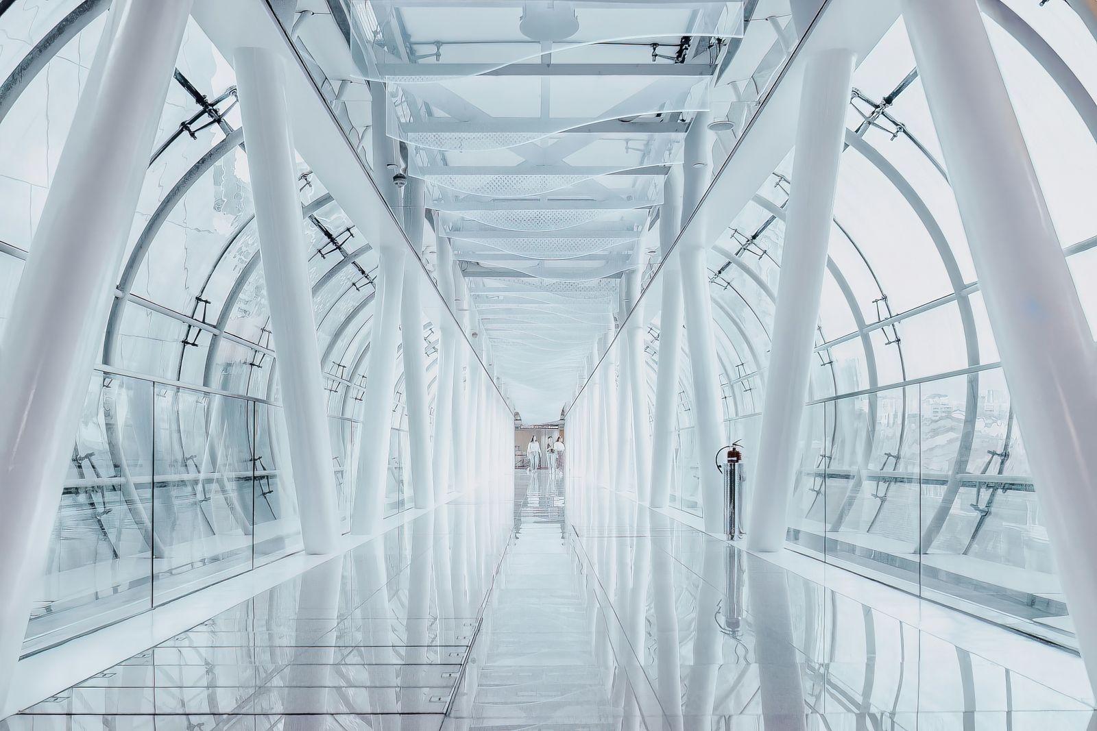 a man is walking down a long hallway